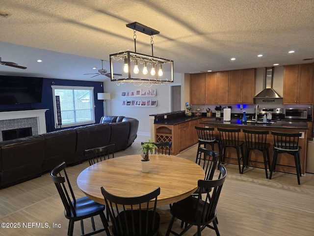 10 Quail Ln, Jacksonville Beach, FL 32250 - dining space featuring ceiling fan, a tile fireplace, and a textured ceiling