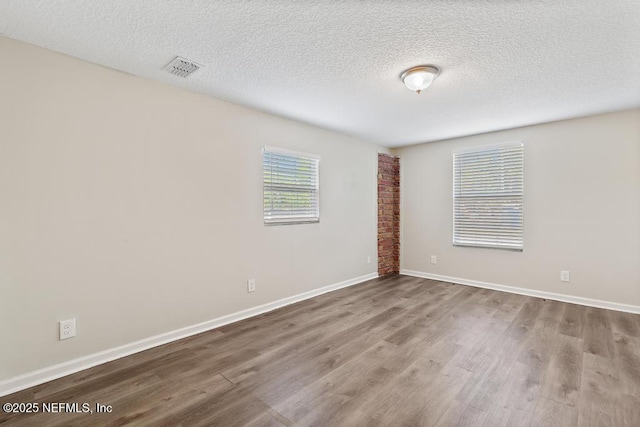 6504 Brandemere Rd S, Jacksonville, FL 32211 - unfurnished room with a textured ceiling, wood finished floors, baseboards, and visible vents