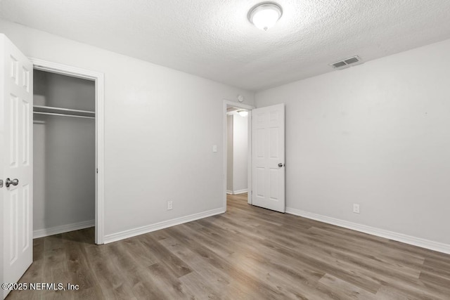 6504 Brandemere Rd S, Jacksonville, FL 32211 - unfurnished bedroom featuring a closet, visible vents, a textured ceiling, and wood finished floors