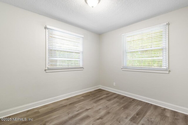 6504 Brandemere Rd S, Jacksonville, FL 32211 - unfurnished room with a textured ceiling, baseboards, and wood finished floors