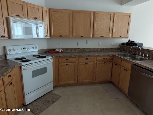 124 Hondo Dr, Saint Augustine, FL 32086 - kitchen with dark countertops, white appliances, and a sink