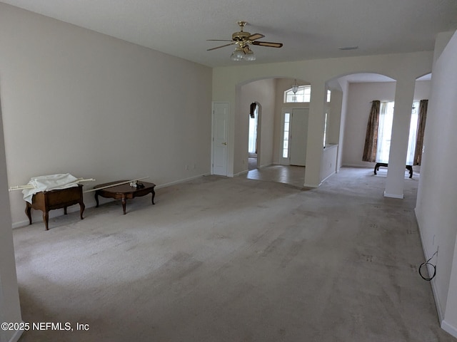 124 Hondo Dr, Saint Augustine, FL 32086 - interior space featuring ceiling fan, light carpet, baseboards, and arched walkways