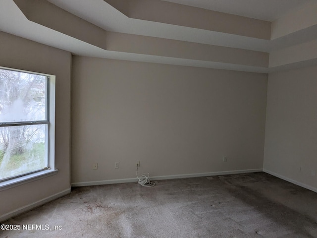 124 Hondo Dr, Saint Augustine, FL 32086 - carpeted empty room with baseboards and plenty of natural light
