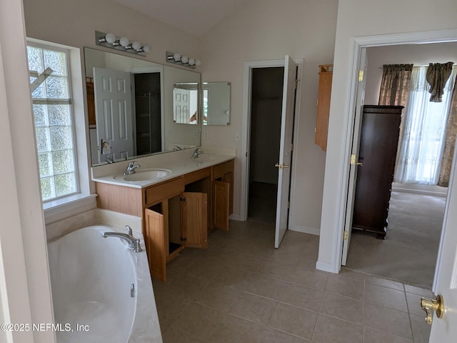 124 Hondo Dr, Saint Augustine, FL 32086 - bathroom with vaulted ceiling, a garden tub, tile patterned flooring, and a sink