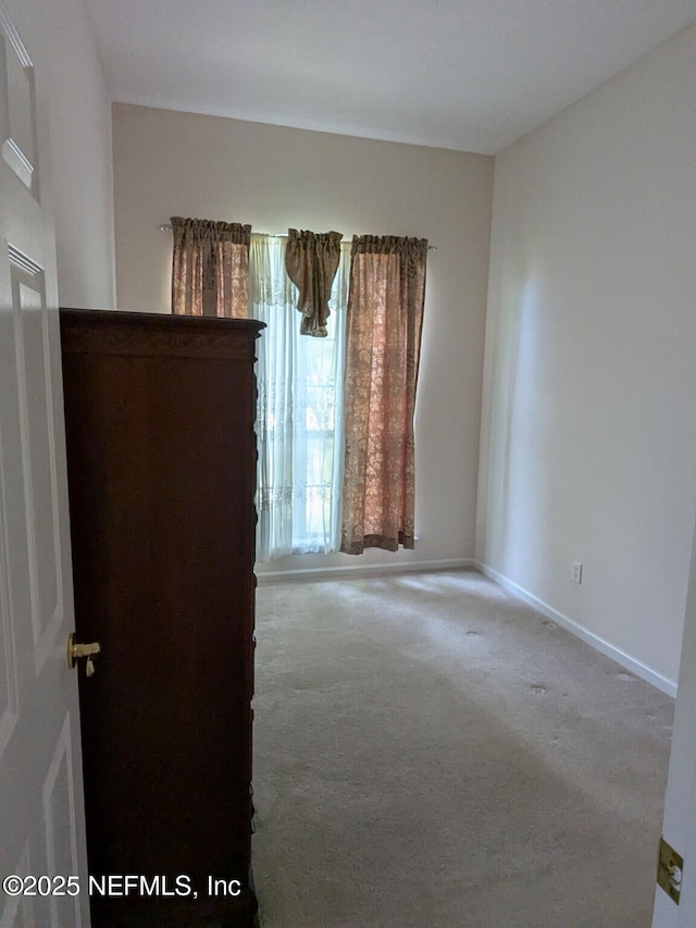 124 Hondo Dr, Saint Augustine, FL 32086 - carpeted empty room featuring baseboards