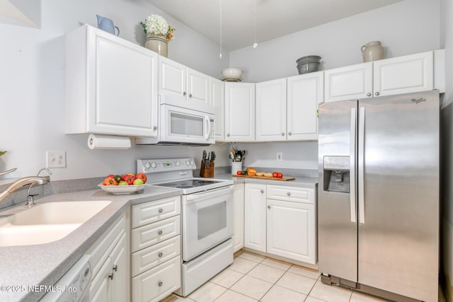 2229 Vista Cove Rd, Saint Augustine, FL 32084 - kitchen featuring white appliances, a sink, light tile patterned floors, white cabinetry, and light countertops