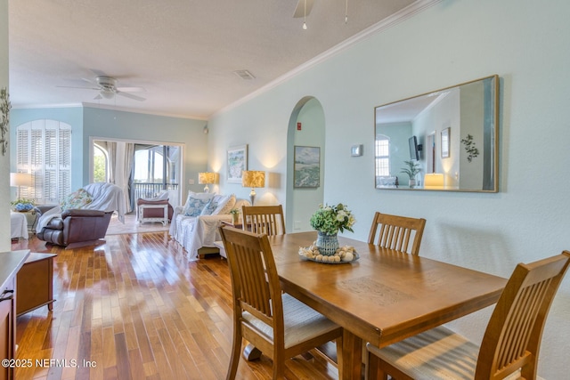 2229 Vista Cove Rd, Saint Augustine, FL 32084 - dining space with ceiling fan, wood finished floors, arched walkways, and ornamental molding