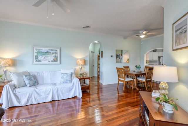 2229 Vista Cove Rd, Saint Augustine, FL 32084 - living room featuring arched walkways, ceiling fan, wood finished floors, and crown molding