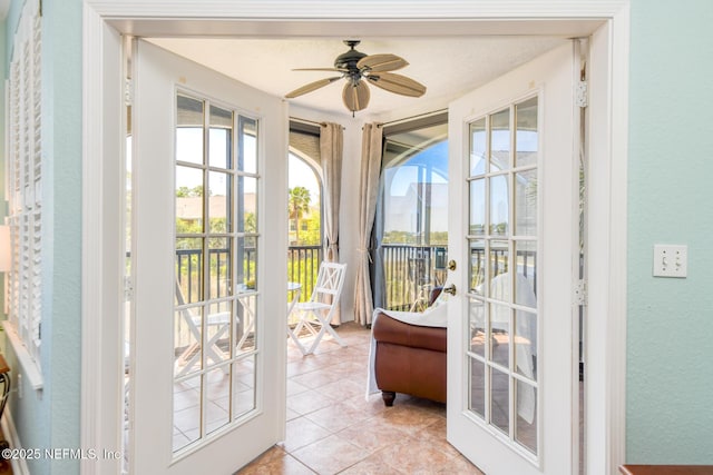 2229 Vista Cove Rd, Saint Augustine, FL 32084 - doorway to outside with ceiling fan, light tile patterned flooring, and a textured wall