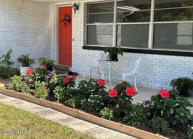 property entrance featuring brick siding