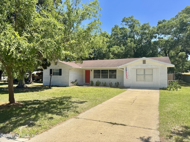 ranch-style house with a front yard, brick siding, and concrete driveway