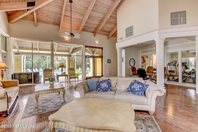 living area featuring visible vents, ceiling fan, high vaulted ceiling, and wooden ceiling