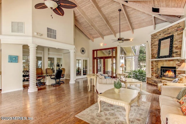 living room with wooden ceiling, high vaulted ceiling, ceiling fan, and visible vents