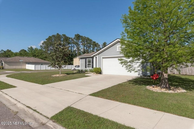 view of front of home featuring concrete driveway, fence, a garage, and a front yard