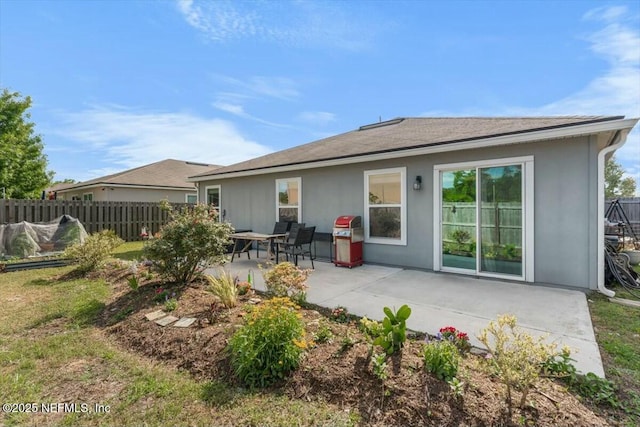 back of property with a patio and fence