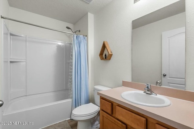 full bathroom with a textured ceiling, toilet, vanity, and shower / bath combo with shower curtain