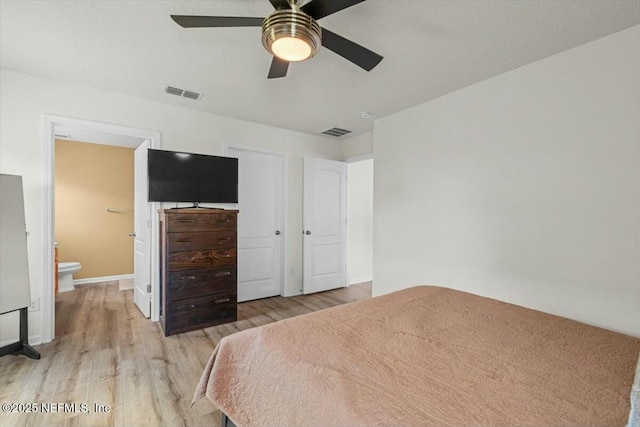 bedroom with ensuite bath, a ceiling fan, visible vents, and light wood-type flooring