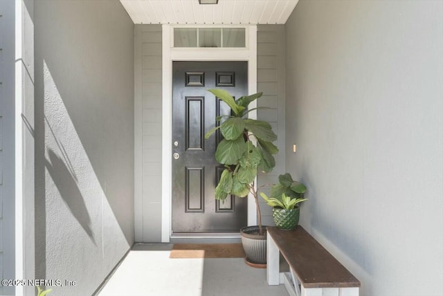 view of exterior entry featuring stucco siding