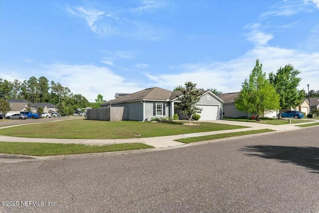 single story home featuring an attached garage, a front lawn, a residential view, and concrete driveway