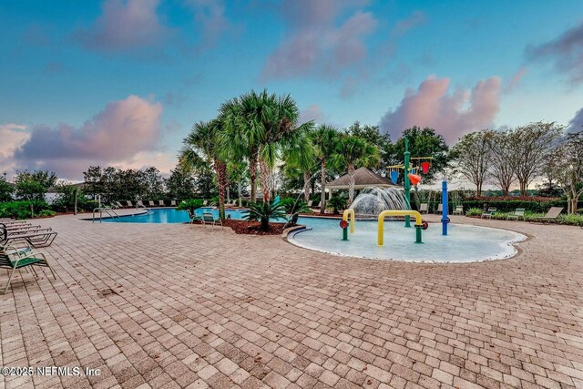 exterior space with a community pool and a patio area