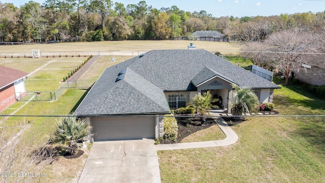 4565 SE 3rd Pl, Keystone Heights, FL 32656 - view of front of property featuring a shingled roof, an attached garage, fence, concrete driveway, and a front lawn