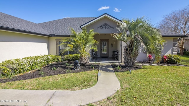 4565 SE 3rd Pl, Keystone Heights, FL 32656 - property entrance featuring a yard, stucco siding, and a shingled roof