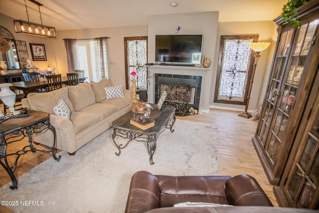 4565 SE 3rd Pl, Keystone Heights, FL 32656 - living room with a tile fireplace, baseboards, and wood finished floors