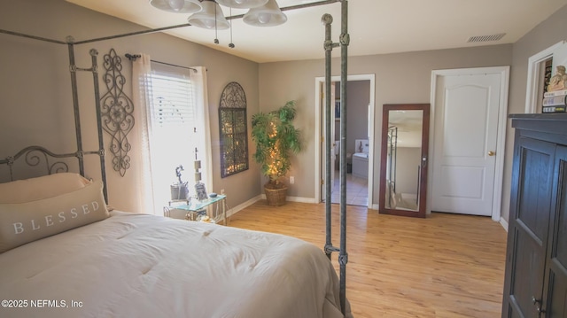 4565 SE 3rd Pl, Keystone Heights, FL 32656 - bedroom featuring light wood-style flooring, baseboards, visible vents, and connected bathroom