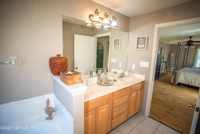 4565 SE 3rd Pl, Keystone Heights, FL 32656 - bathroom with a tub to relax in, a ceiling fan, tile patterned flooring, a sink, and double vanity