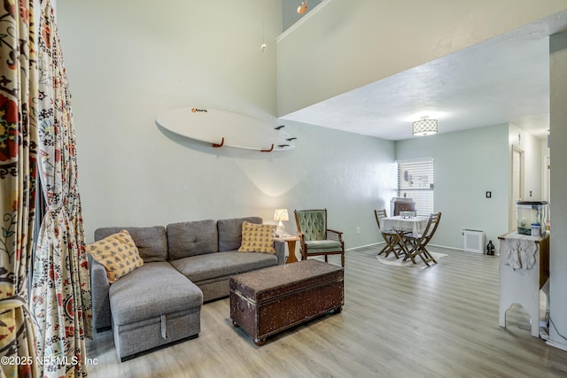 living room with baseboards and wood finished floors