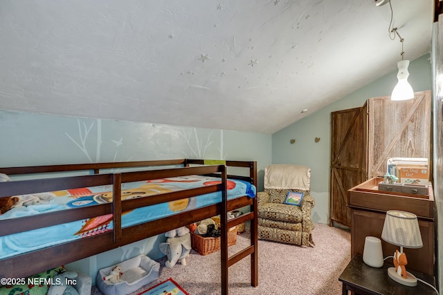 bedroom featuring light colored carpet and vaulted ceiling