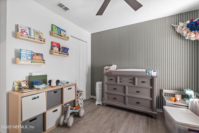 2916 Duck Hollow Ln, Green Cove Springs, FL 32043 - bedroom with wood finished floors, a closet, a ceiling fan, and a textured ceiling