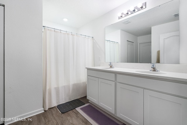 2916 Duck Hollow Ln, Green Cove Springs, FL 32043 - full bath with wood finished floors, double vanity, a shower with curtain, and baseboards