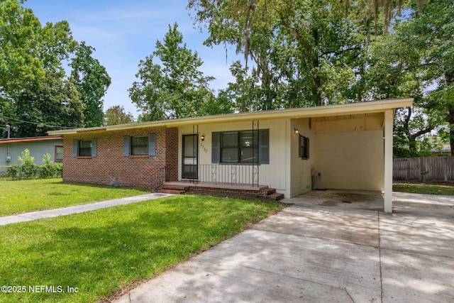 single story home featuring a carport, covered porch, fence, concrete driveway, and a front lawn