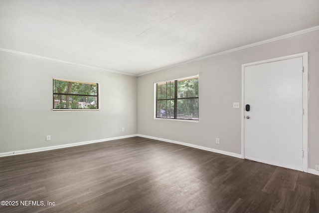 interior space featuring baseboards, ornamental molding, and dark wood finished floors