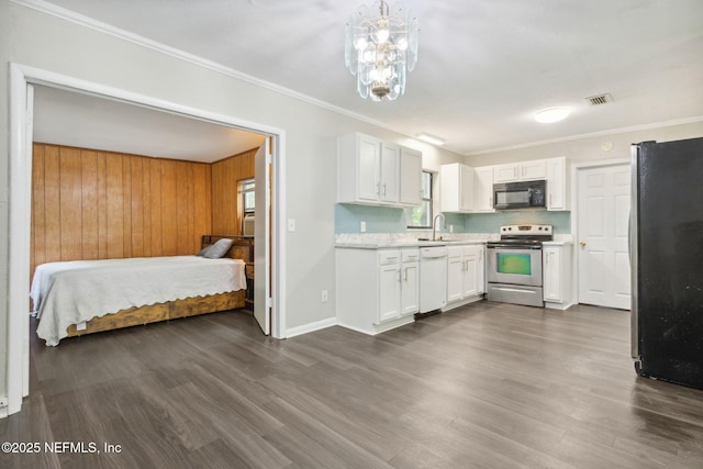kitchen with light countertops, a sink, dark wood-style floors, and stainless steel appliances