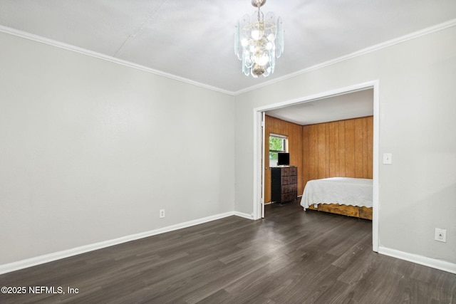 bedroom featuring a chandelier, dark wood-style flooring, baseboards, and crown molding