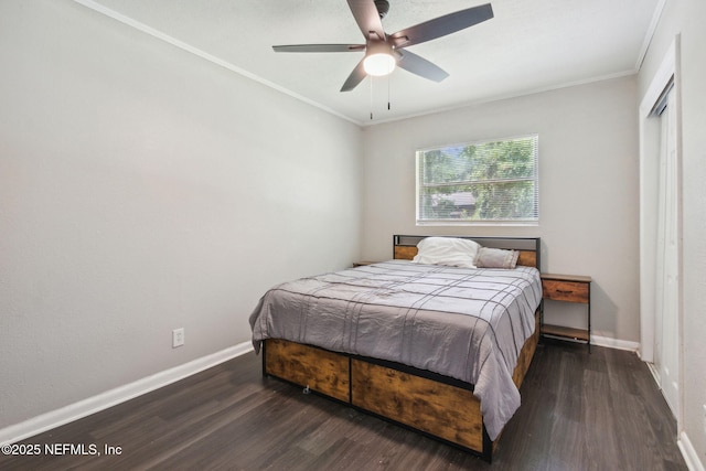 bedroom with a closet, baseboards, ornamental molding, a ceiling fan, and wood finished floors