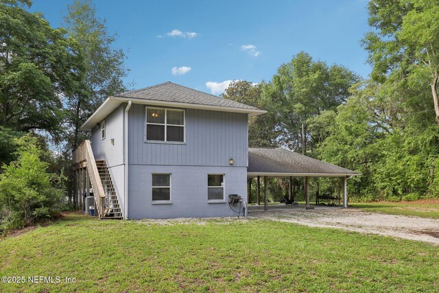 6470 Brooklyn Bay Rd, Keystone Heights, FL 32656 - back of property featuring driveway, stairs, a yard, an attached carport, and a shingled roof