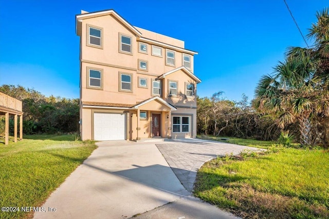 view of front of property with a garage, stucco siding, concrete driveway, and a front yard