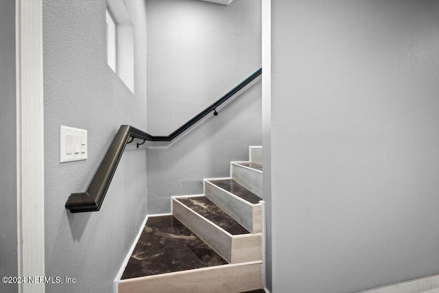 staircase with marble finish floor