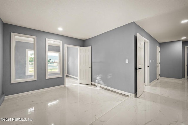 interior space featuring recessed lighting, baseboards, and marble finish floor