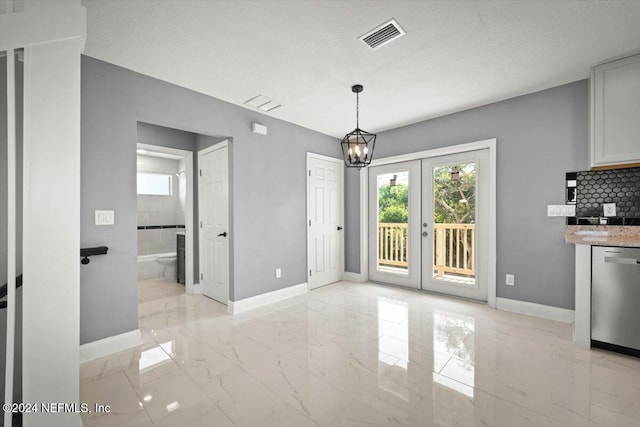 unfurnished dining area featuring french doors, visible vents, baseboards, marble finish floor, and a notable chandelier