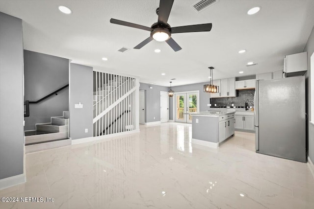 unfurnished living room featuring visible vents, marble finish floor, baseboards, ceiling fan, and recessed lighting