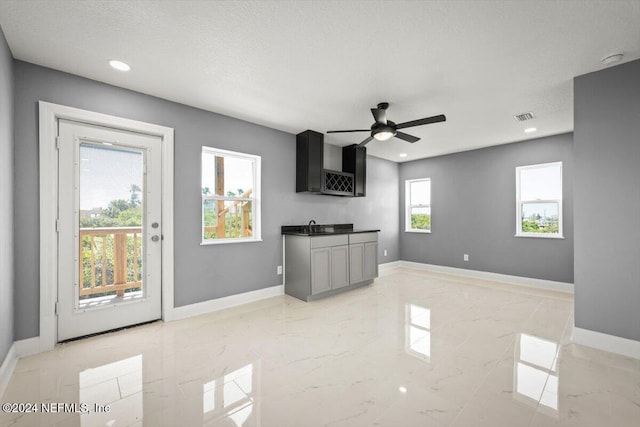kitchen featuring baseboards, a ceiling fan, marble finish floor, and visible vents