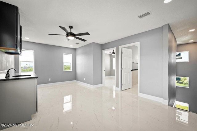 interior space with visible vents, marble finish floor, ceiling fan, recessed lighting, and a sink