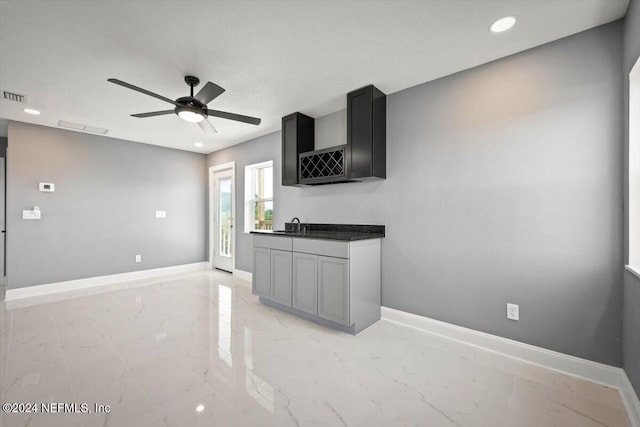 kitchen featuring baseboards, ceiling fan, recessed lighting, and marble finish floor