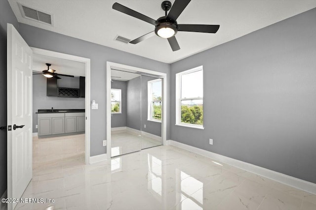 unfurnished bedroom with visible vents, baseboards, and multiple windows