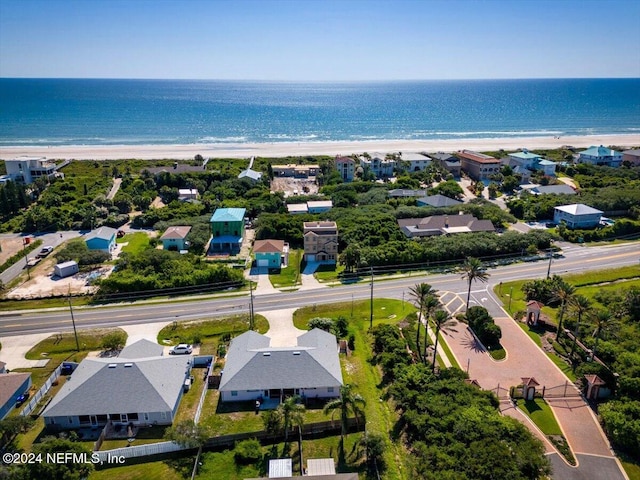 drone / aerial view featuring a water view and a view of the beach