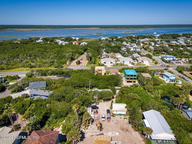 drone / aerial view with a water view and a residential view